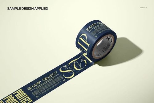 Wide masking tape roll mockup with dark blue and yellow design, unrolled on a light surface, front angle view.