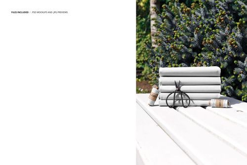 PSD mockup showing light gray fabric pieces stacked on a garden bench, surrounded by greenery and small objects.