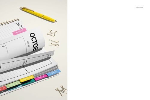 Open planner mockup with visible weekly and monthly pages, spiral binding, yellow pen, and gold paper clips.