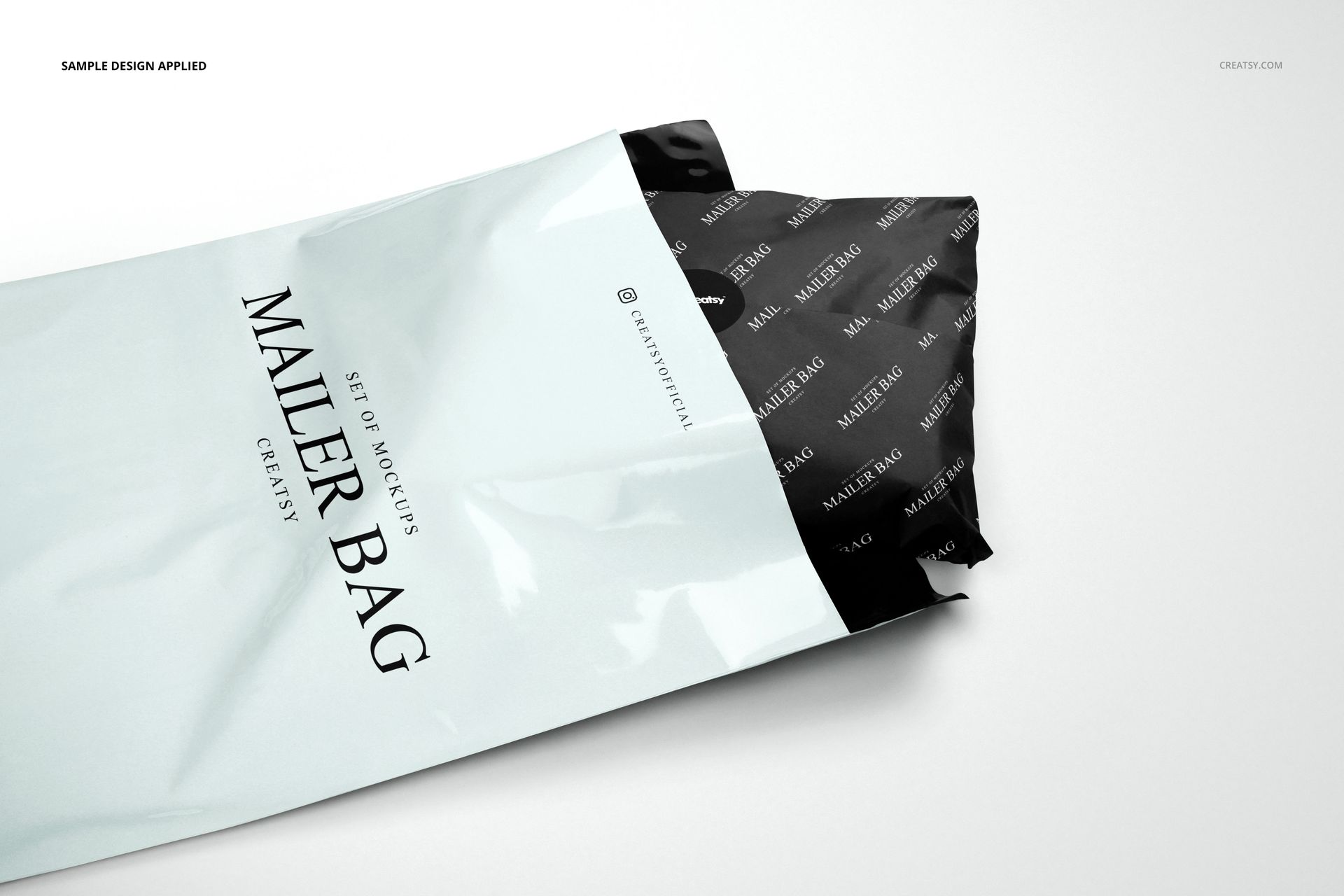 Mailer bag mockup set shown with white exterior and black wrapping tissue paper featuring a subtle pattern.