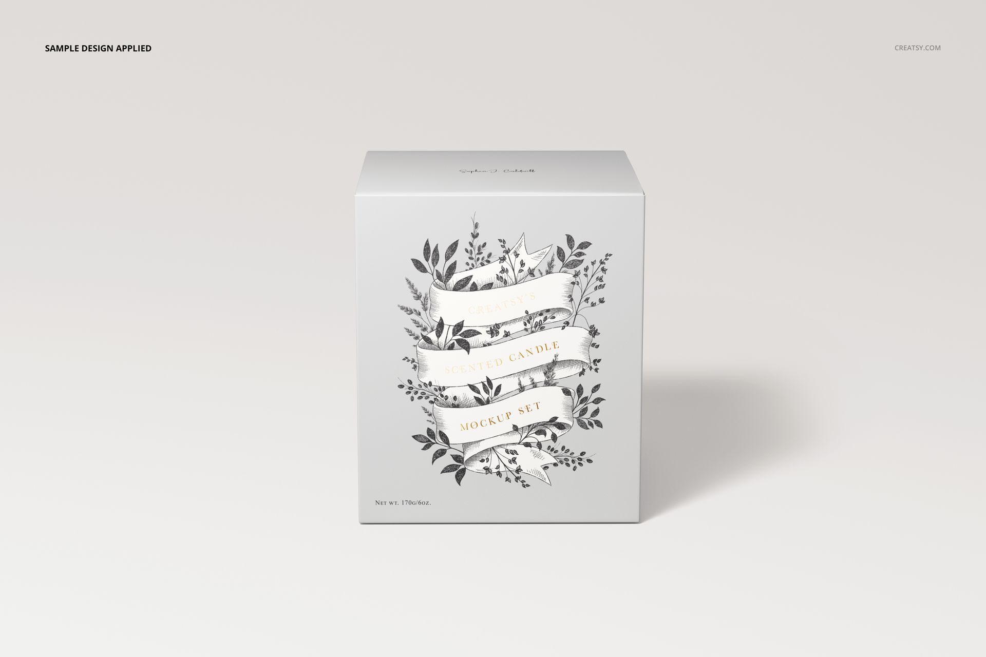 Square candle packaging mockup featuring floral artwork and decorative text, shown on a minimalist white surface.
