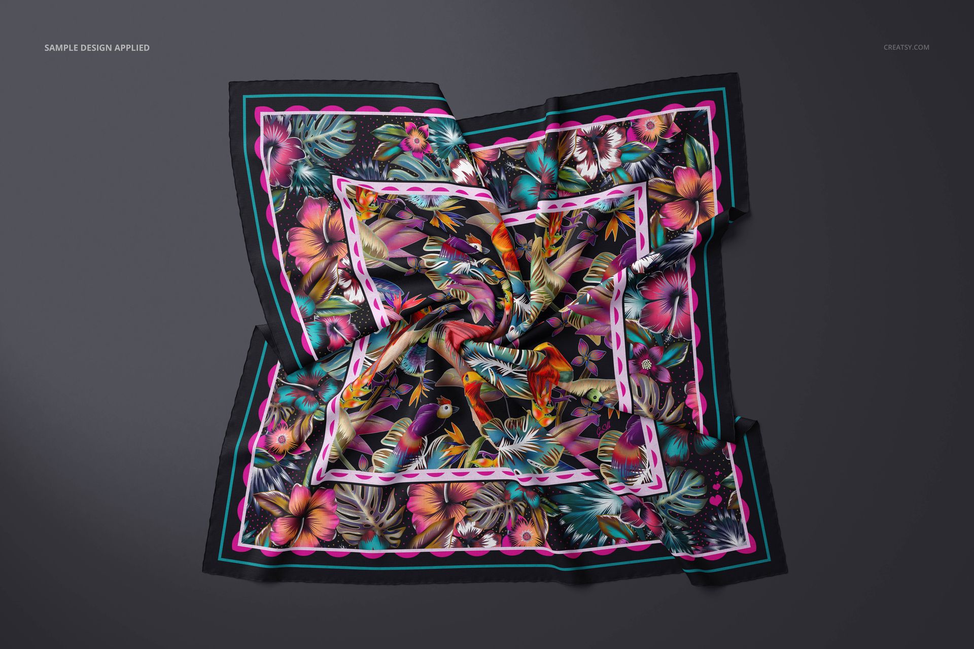 Colorful floral cashmere scarf mockup shown from above, featuring pink, green, and orange accents on dark fabric.