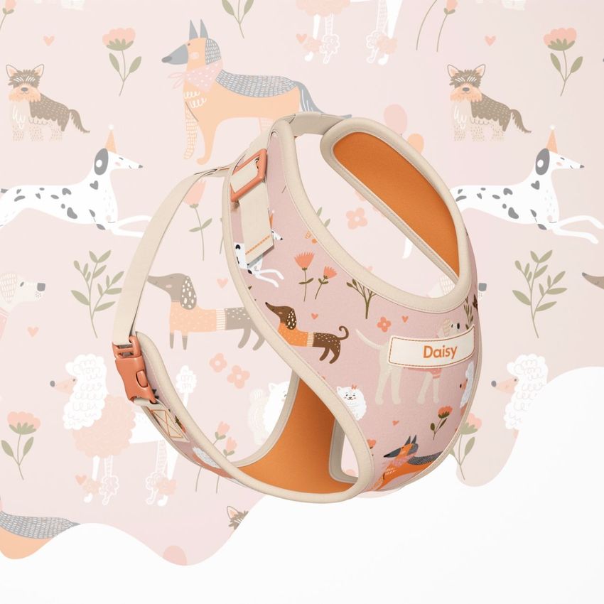 Dog harness mockup featuring a pastel pink design with illustrated dogs, flowers, and the name Daisy, set against a matching patterned background.