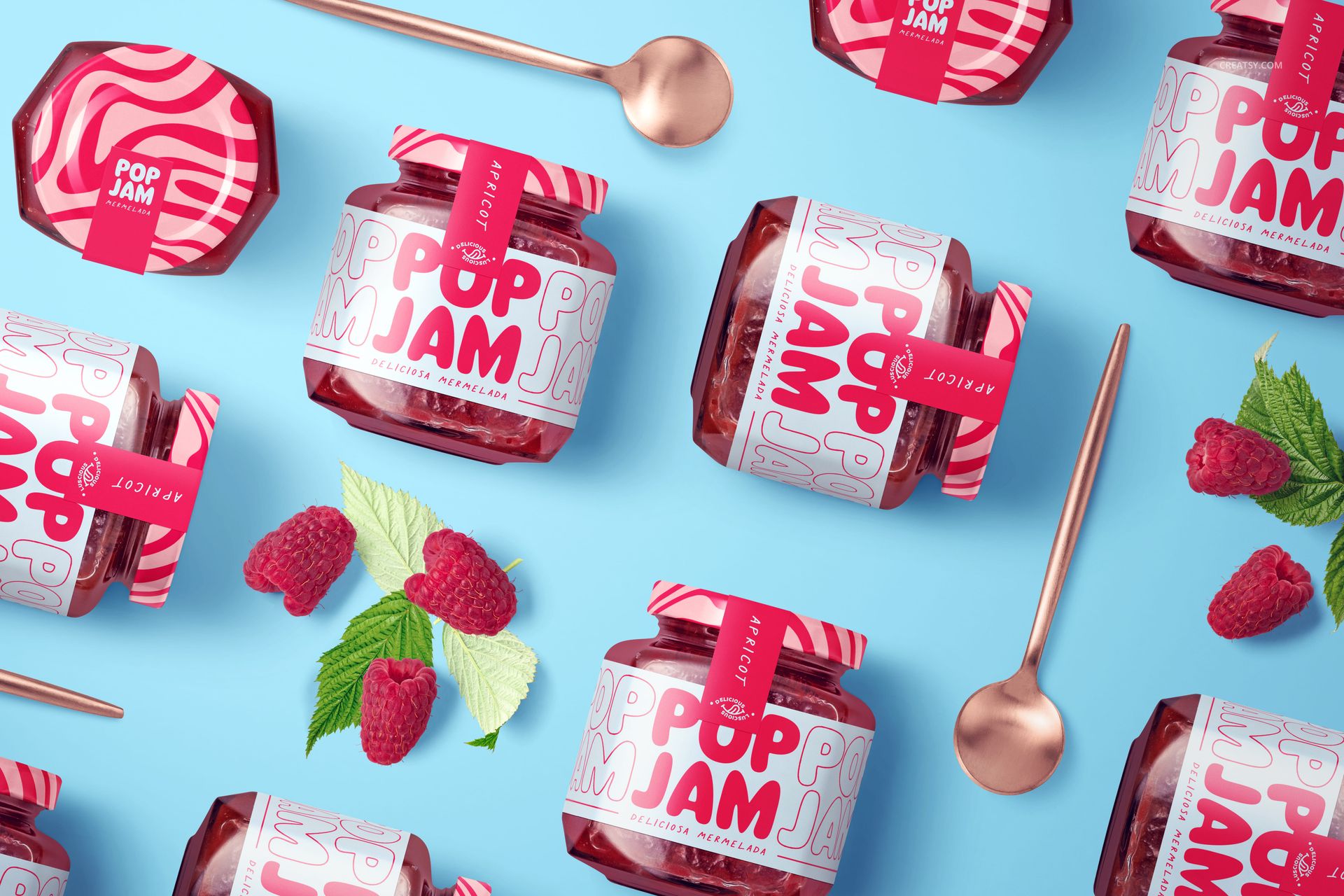 Front view of jam jar mockups featuring vibrant red fruit preserves, decorative labels, and scattered raspberries on blue background.
