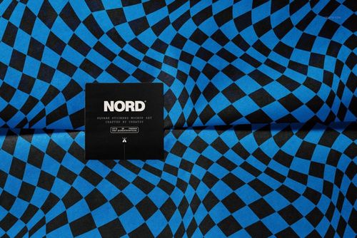Square stickers mockup featuring a black sticker with white text placed on a blue and black wavy checkered background.