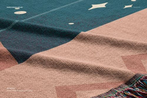 Close-up of a fringed jacquard throw blanket mockup, displaying textured fabric with abstract patterns in soft colors.