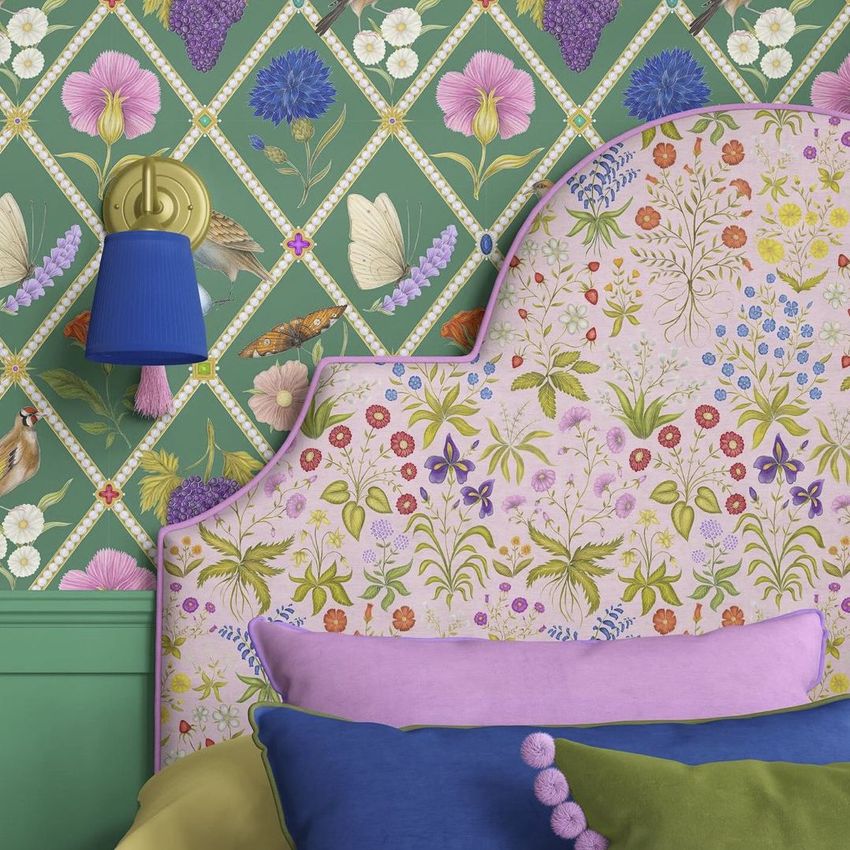 Bedroom mockup featuring a floral headboard, colorful pillows, and green wallpaper with botanical and butterfly patterns.