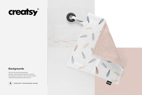 Mockup of a soft teething blanket featuring a feather print, silicone ring, and removable label on a light surface.