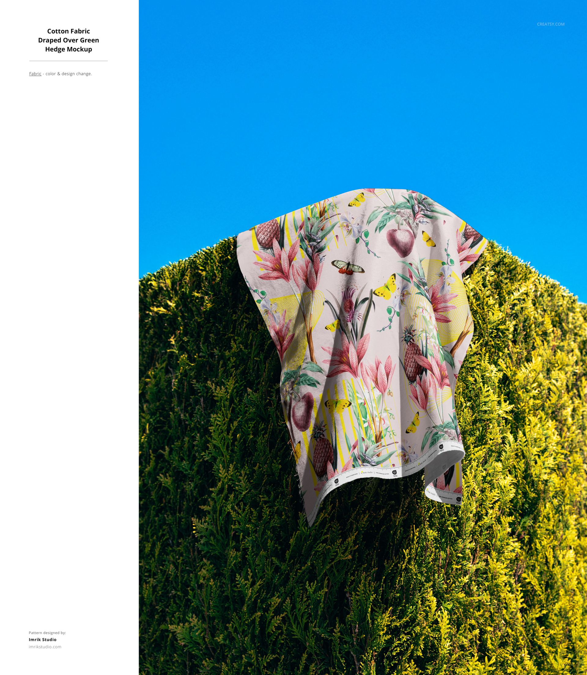 Floral and butterfly print fabric mockup displayed on a trimmed hedge with bright natural lighting and vivid blue sky.