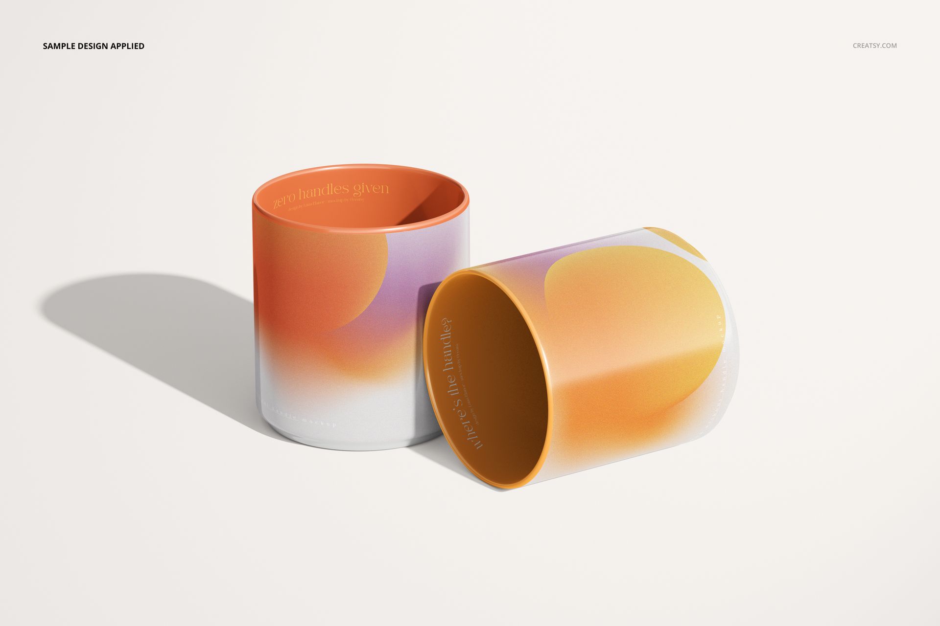 Pair of handleless mugs with rounded edges, decorated in soft orange and purple hues, shown in a realistic mockup scene.