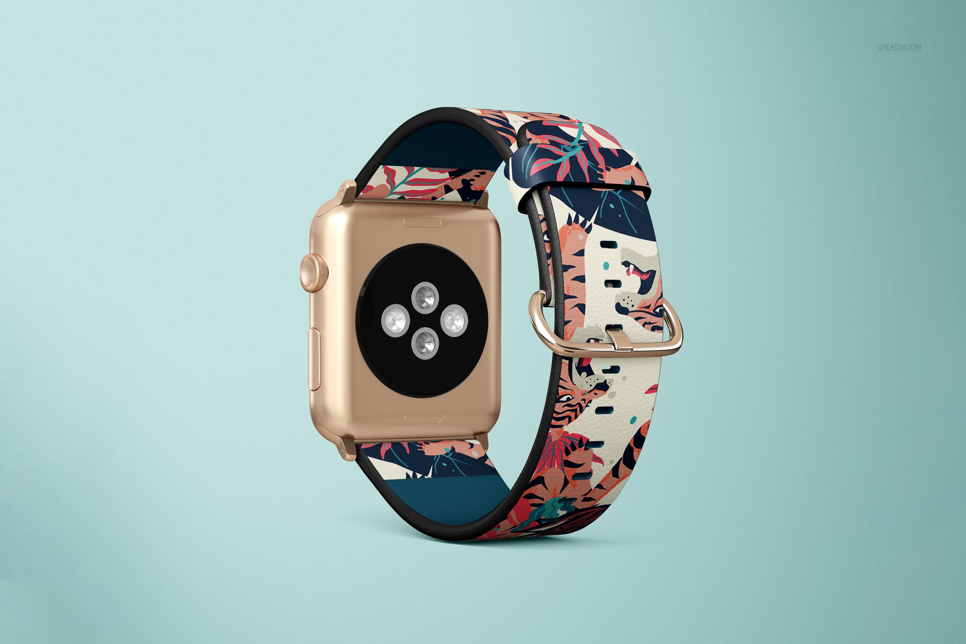 PSD mockup of an Apple Watch with a patterned leather band, gold case, and silver buckle on a soft blue backdrop.