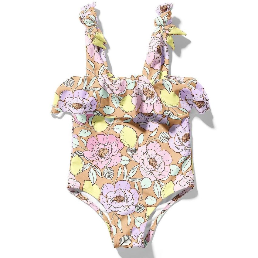 Baby swimsuit mockup featuring a pastel floral pattern with large pink and yellow flowers on a light brown background, shown flat.