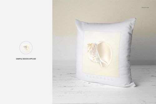 Mockup of a white square pillow featuring a seashell illustration, placed against a light beige wall background.