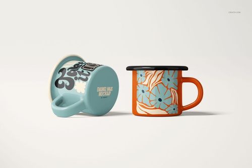 Two enamel mugs displayed on a light surface, one upright with a floral pattern and one lying on its side showing text.