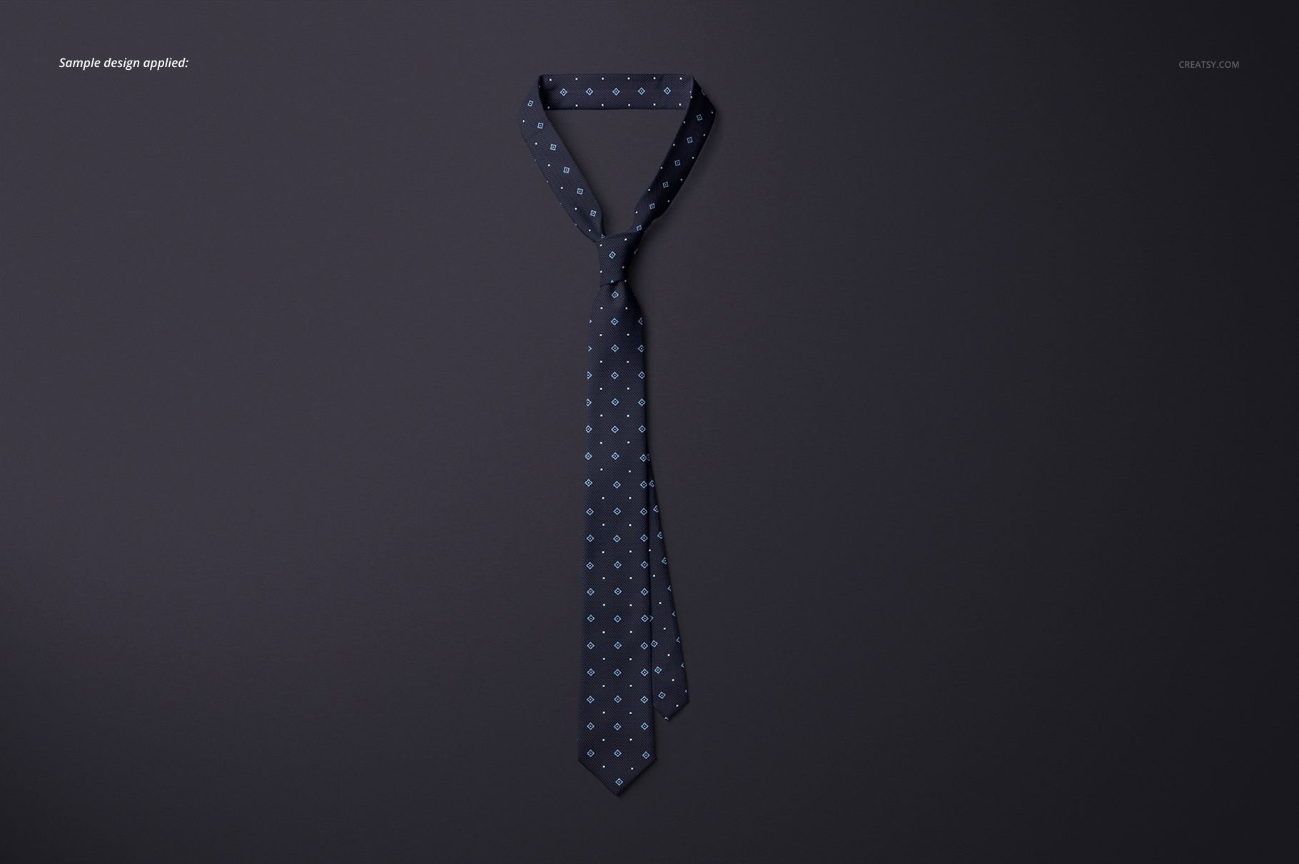 Necktie mockup featuring a navy tie with repeating light blue motif, arranged neatly on a plain surface.
