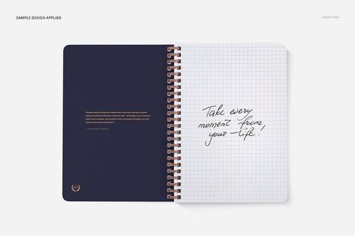 Open notebook mockup with square grid pages, spiral binding, and handwritten text on the right page, top view.