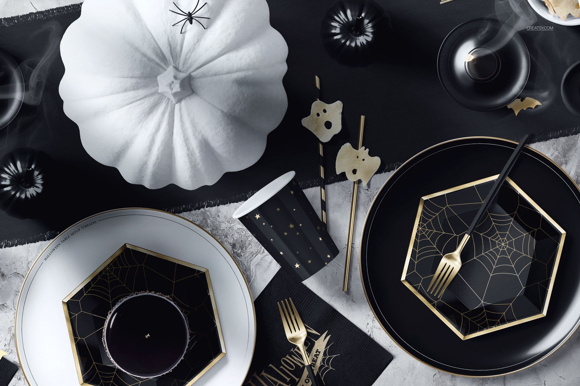 Halloween PSD mockup showing a decorated table with geometric plates, spider motifs, utensils, and themed accessories.