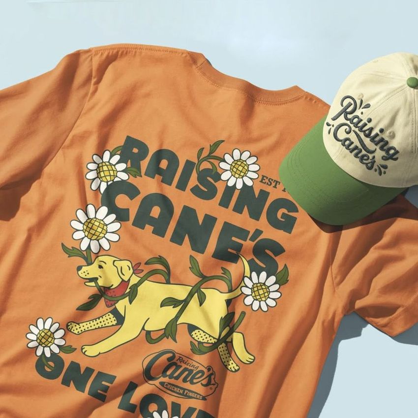 T-shirt and cap mockup featuring an orange shirt with floral and dog illustration, and a beige-green cap with script text.
