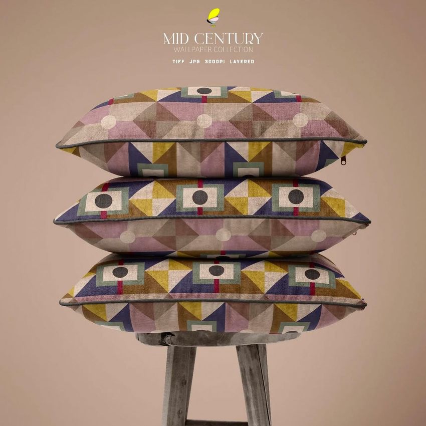 Stack of three reversible piped cushions with geometric mid-century patterns in muted tones, displayed on a wooden stool.