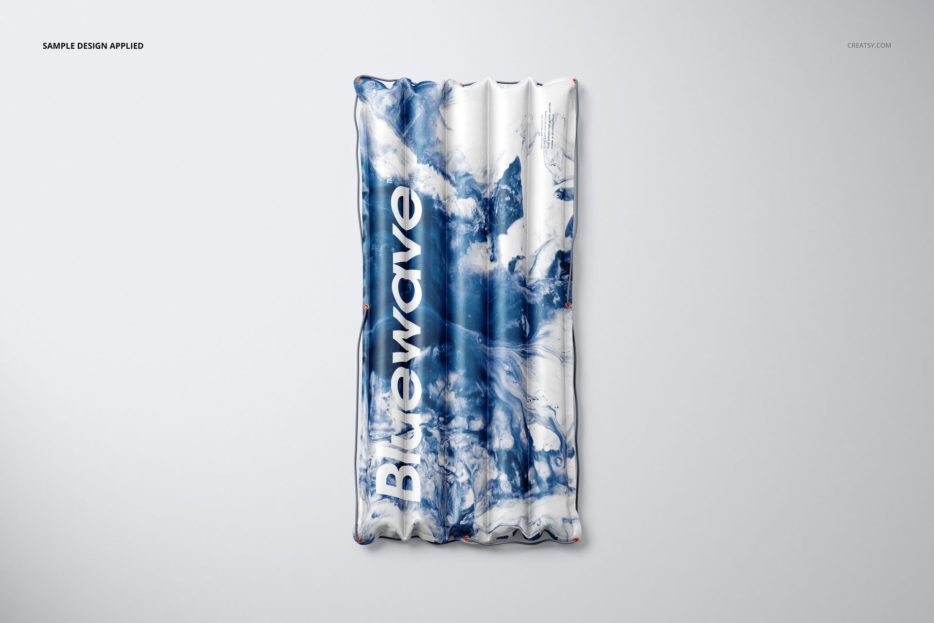 PSD mockup of an inflatable swimming raft with bold blue and white abstract pattern, displayed from a top-down perspective.