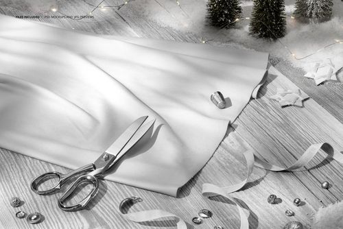 Jersey fabric mockup in a winter Christmas scene, displayed on a wooden surface with scissors and festive decor.