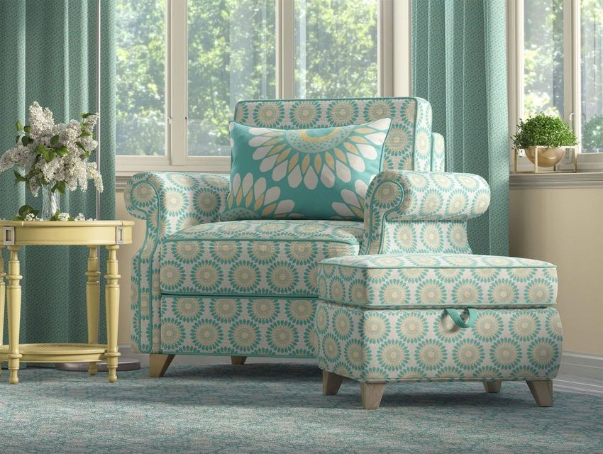 Victorian style armchair and ottoman mockup in a living room, upholstered with a turquoise daisy seamless pattern, near a window.
