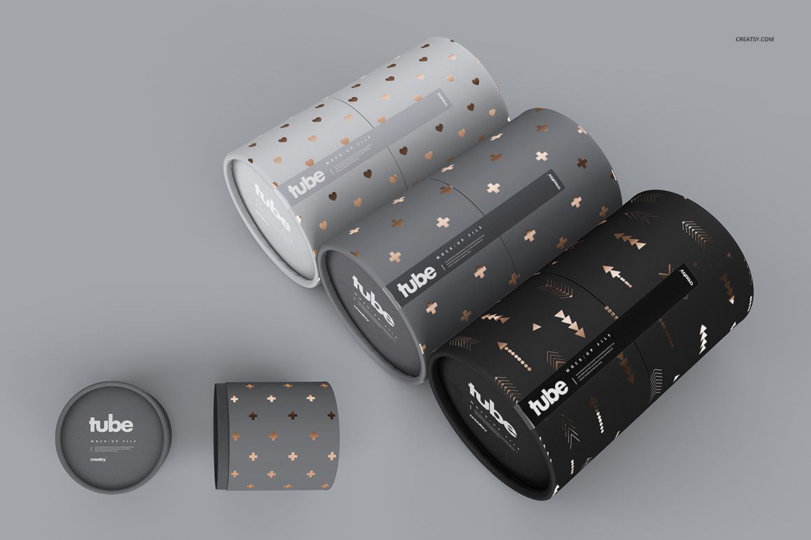 Set of paper tube packaging mockups in various shades of gray and black, featuring gold and copper decorative motifs.
