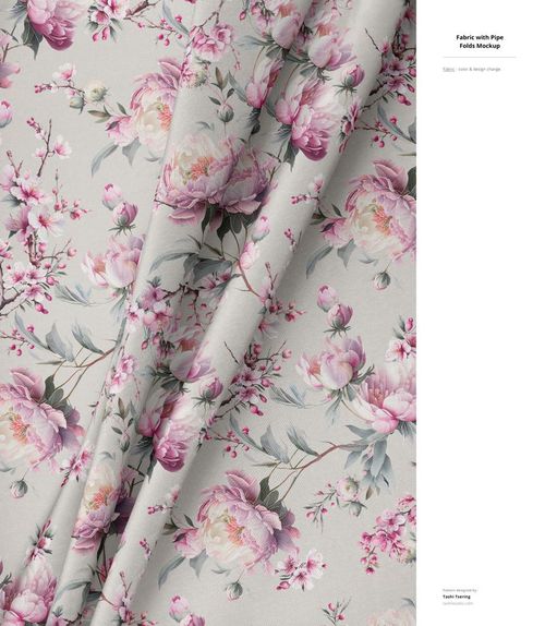 PSD mockup showing folded fabric with soft pink and white flower design and green leaves on a pale surface.