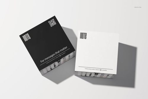 Two square note cubes with minimalist black and white covers displayed on a light surface in a stationery mockup.