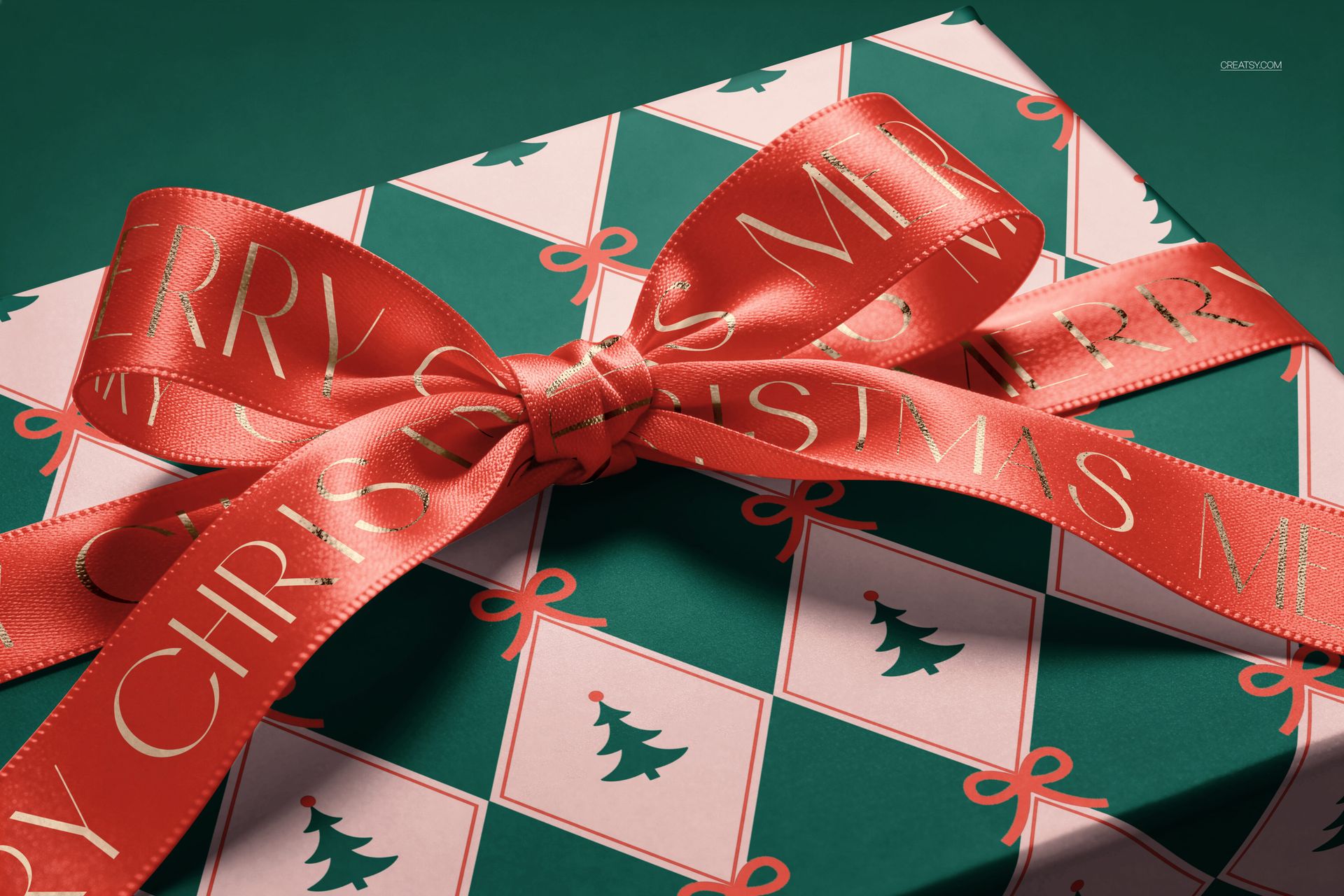 PSD mockup of a holiday gift box decorated with geometric tree design and a wide red ribbon, viewed from above.