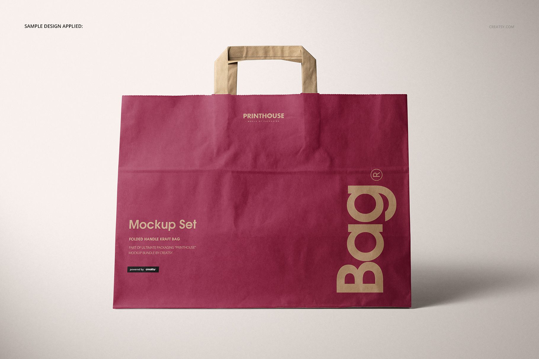 Folded handle kraft paper bag mockup shown from the front, with a deep red body and beige handles on a neutral surface.