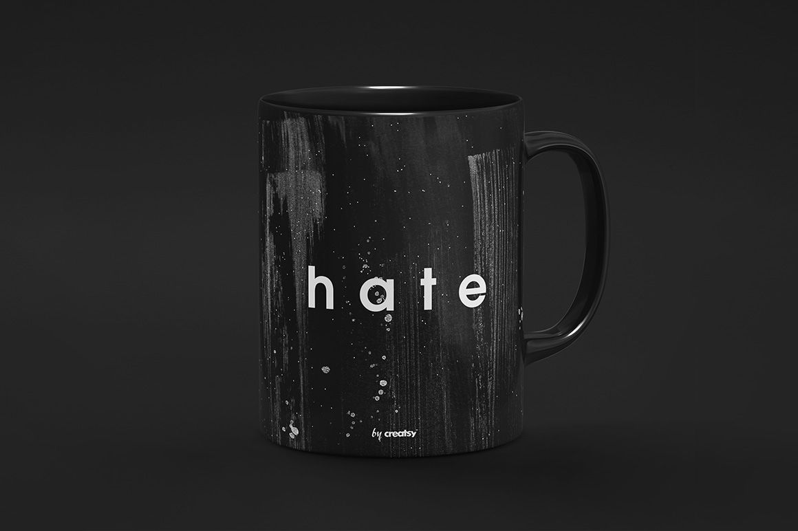PSD mockup of a black drinkware mug with artistic white paint accents and centered text, displayed on a neutral surface.