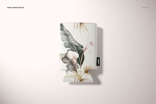 PSD mockup of a neoprene can cooler featuring botanical leaves and flowers, displayed flat against a pale surface.