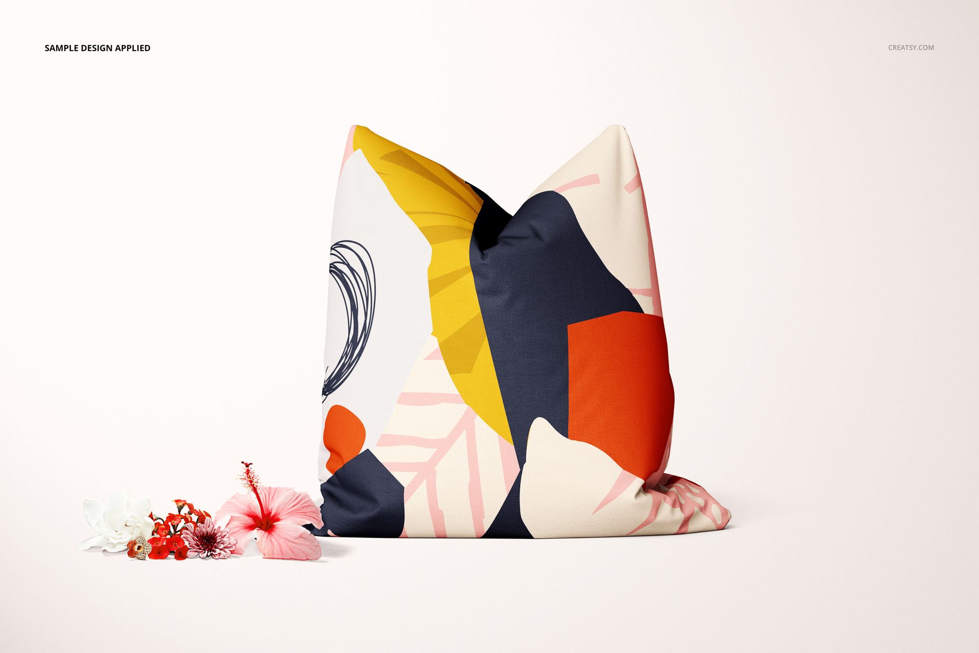 Front-facing decorative pillow mockup featuring bold abstract shapes in navy, orange, yellow, and pink on a white background.