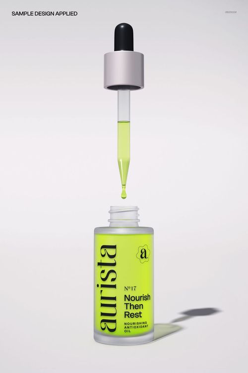 Cosmetic serum bottle mockup featuring a bright yellow label and a dropper with green liquid, shown from the front.