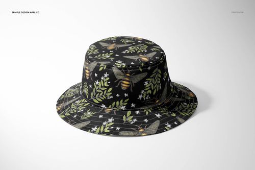 Adult bucket hat mockup displaying a dark fabric decorated with botanical and bee patterns, presented on a white surface.