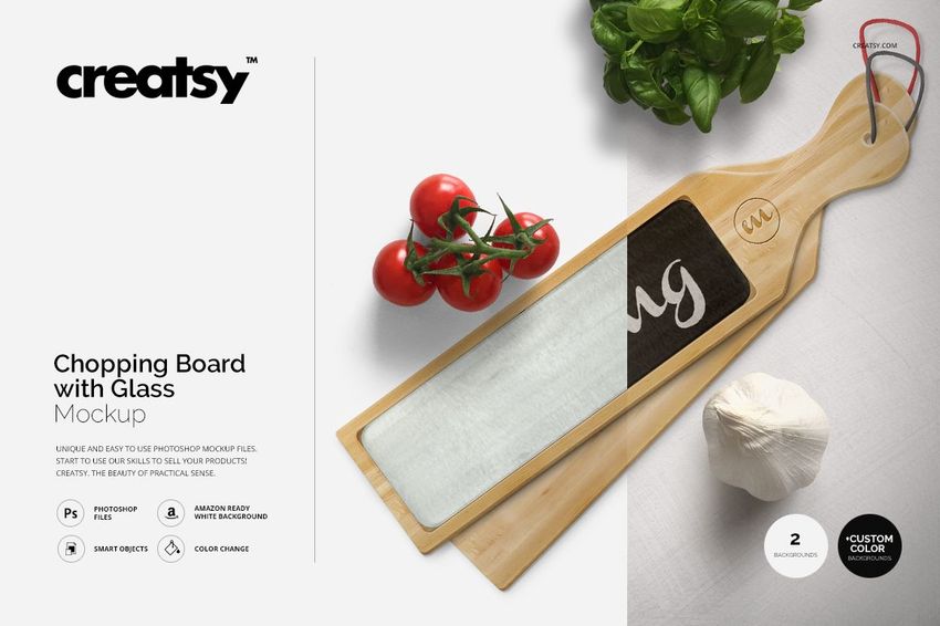 Top view of a wooden chopping board mockup with glass insert, placed on a light surface with tomatoes and garlic.