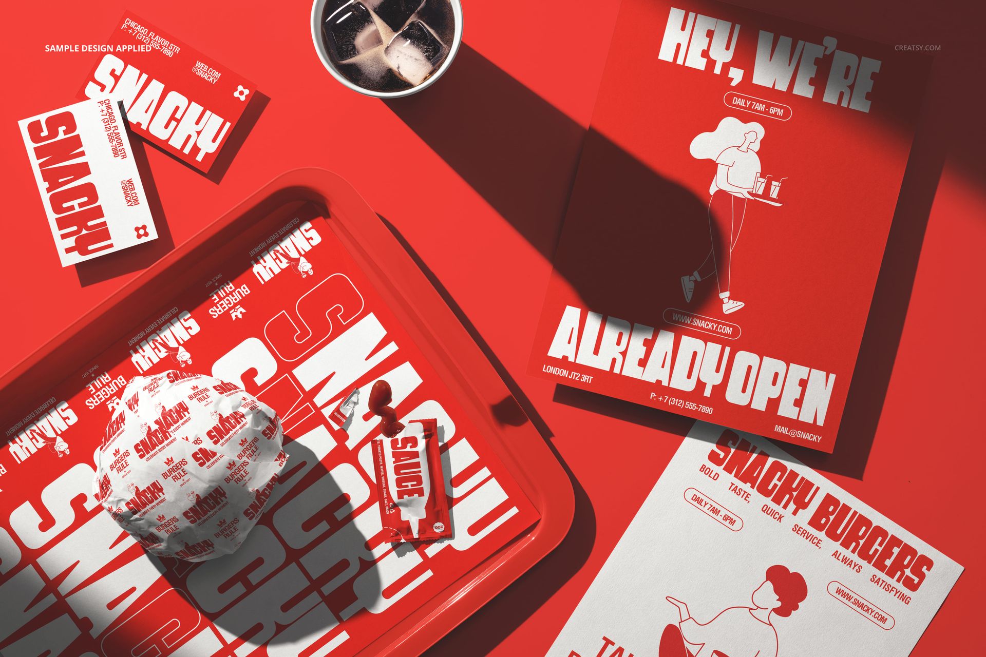 Fast food tray mockup with wrapped burger, fries, cup, and promotional flyers arranged on a vibrant red background.