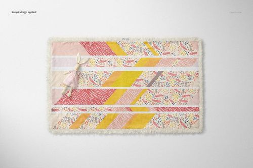 Top view of a sherpa baby blanket mockup featuring stripes in yellow, pink, and multicolored dots, with a stuffed bunny.