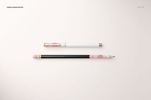 Stationery set mockup featuring a pen and pencil with gold accents and floral patterns on a light background, top view.
