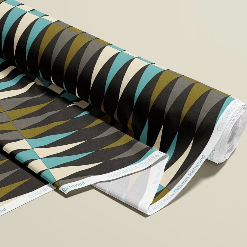 Fabric roll mockup featuring a retro geometric pattern in black, olive green, teal, and beige on a light background.