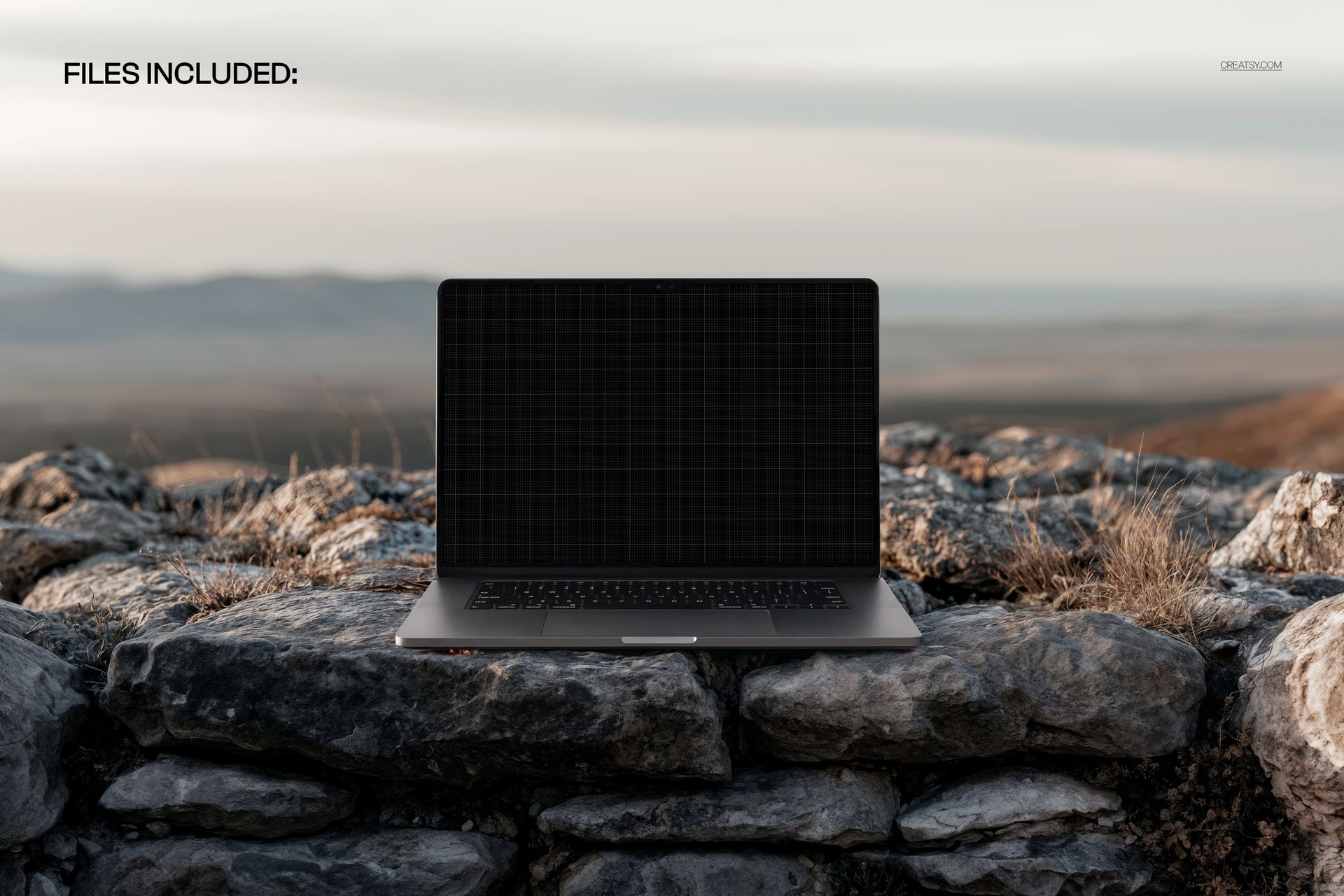 Laptop with dark screen placed on rugged coastal rocks, front view, natural outdoor setting, PSD mockup scene.
