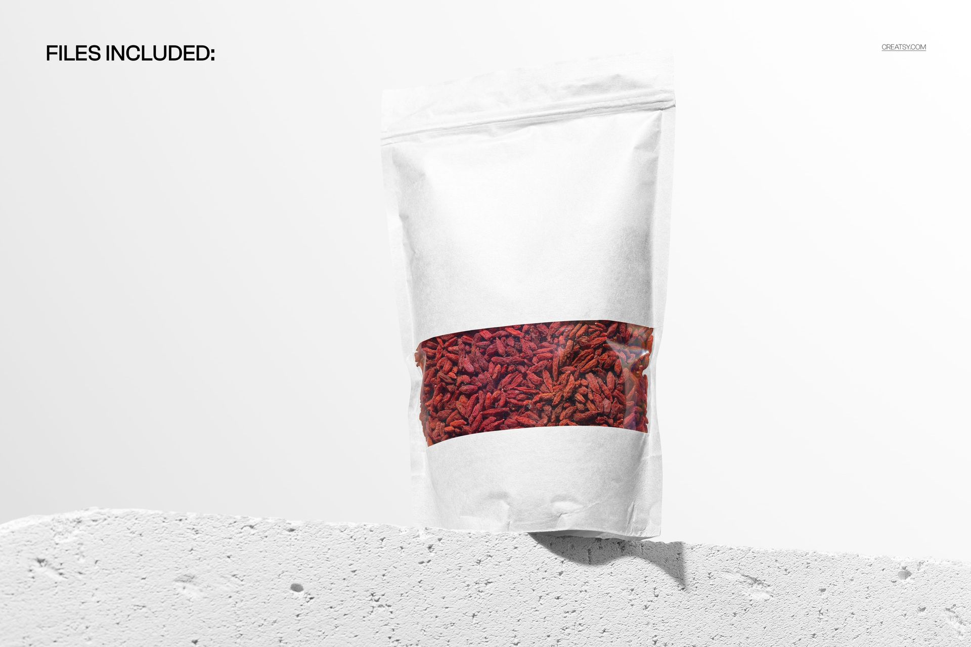 Front view of a white stand up pouch mockup with visible red contents, displayed on a concrete surface against a light background.