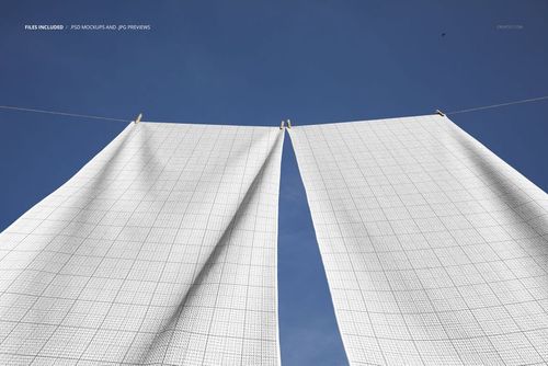 Waffle beach towels mockup showing two large white towels with grid texture hanging outdoors under a blue sky.