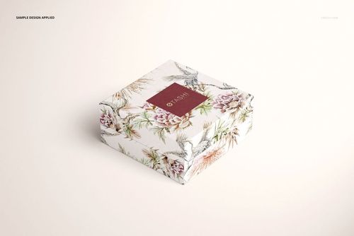 Square jewelry box with floral and bird pattern, viewed from a front angle on a light background, mockup style.