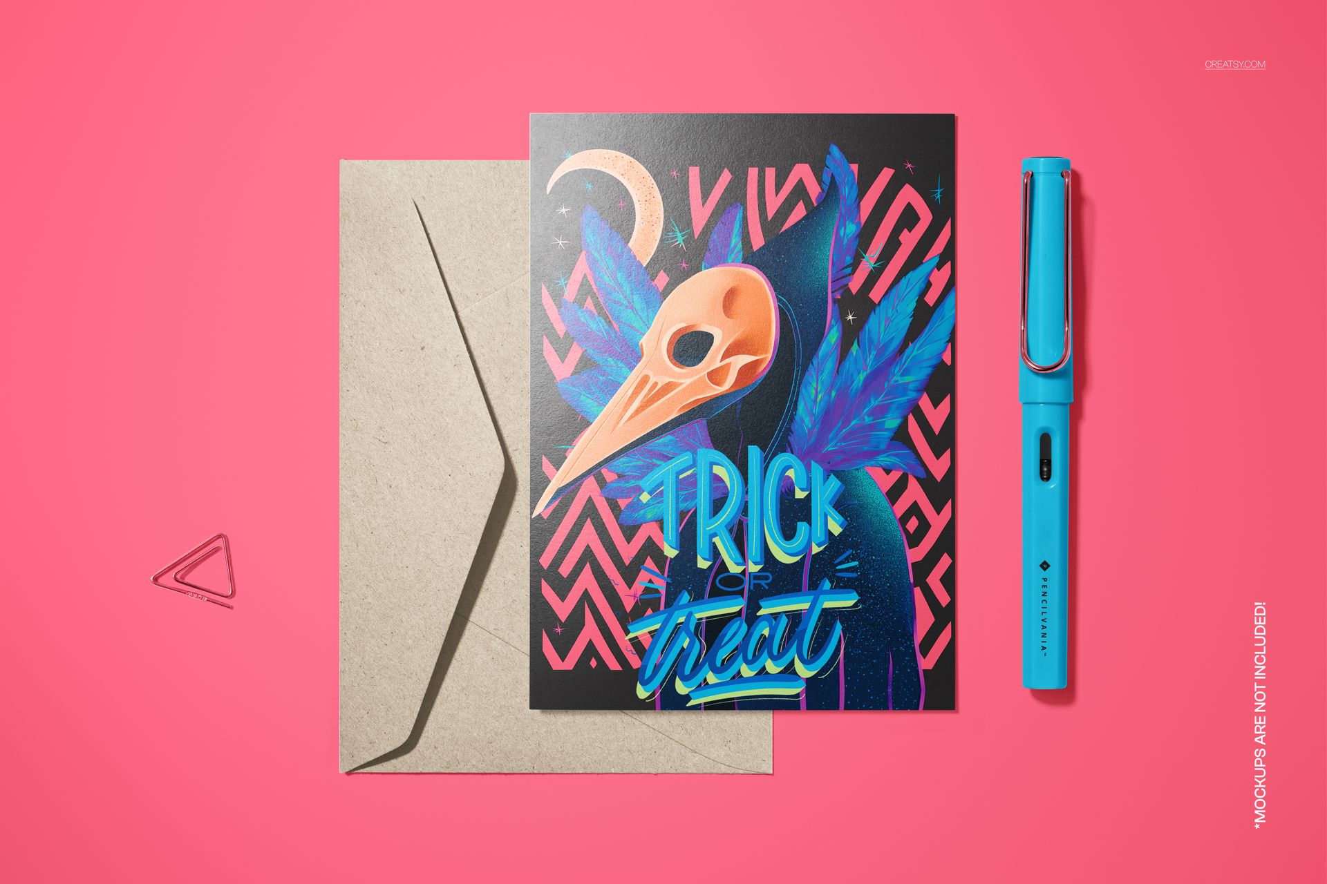 Halloween 5x7 card mockup featuring a vintage raven mask, bold blue elements, and a kraft envelope on a pink surface.