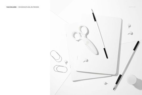 Stationery mockup featuring two plain notebooks, scissors, paintbrushes, and office supplies on a white background.