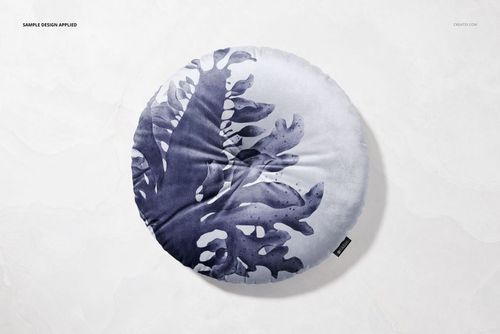 PSD mockup of a round cushion with blue watercolor foliage print, displayed on a neutral stone surface.
