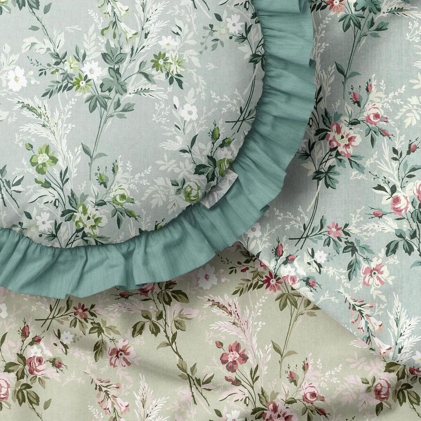 Ruffled pillow mockup featuring a round cushion with a blue-green ruffled edge and floral patterns in soft pastel colors.