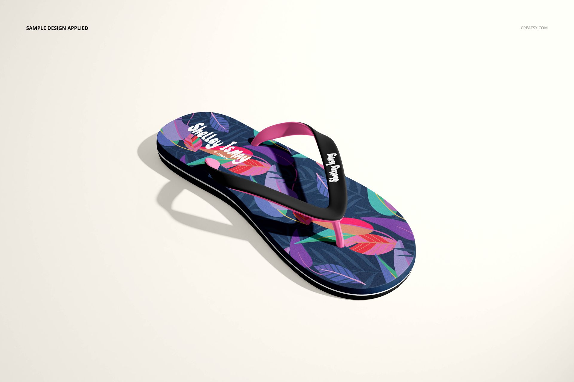 Flip flop mockup featuring a vibrant multicolored leaf design, shown in a three-quarter view on a neutral surface.
